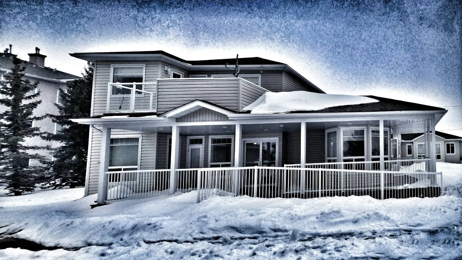 Freedom Living from the front in winter, with snow along the porch
