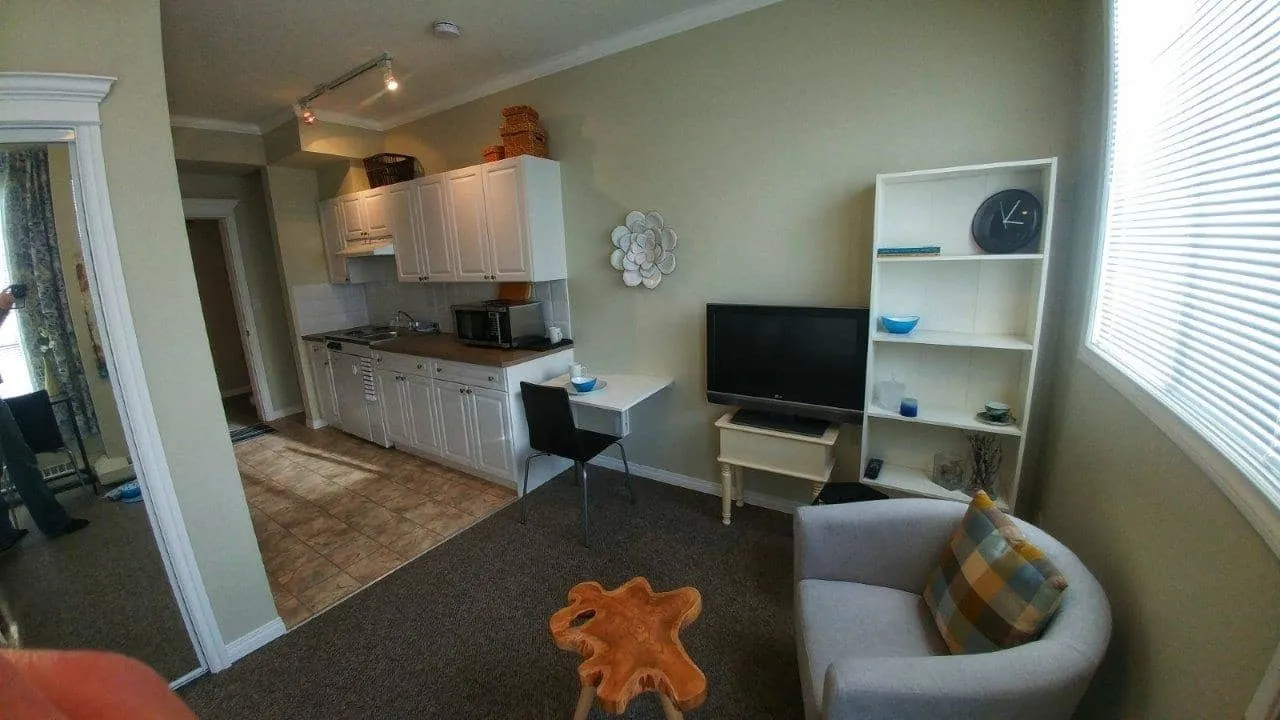 Self-contained suite with kitchenette, desk, TV and an armchair
